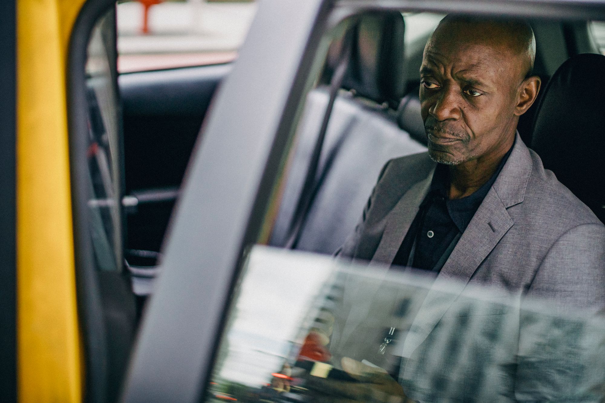 A person sitting in a car before a meeting, thinking.
